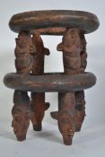 An African Tribal Bamileke pot stand and cover raised on masked supports dating to the late 19th