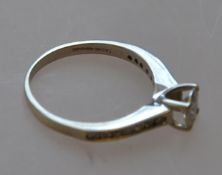 A hallmarked 9ct white gold solitaire ring with prong mount and set shoulders .30 carat 2.6g RS N.