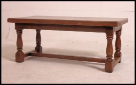 A good Ipswitch oak Jacobean revival coffee table in solid oak raised on block and turned legs