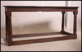 A 17th / 18th century Jacobean / Cromwellian peg jointed oak refectory dining table with a two