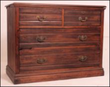 An Edwardian walnut cottage chest of drawers having a 2 short over 2 deep drawers configuration.