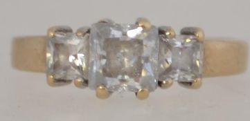 A 9ct gold and 3 stone ( cz) ring. The 3 square cut stones being claw mounted. Total weight 2.