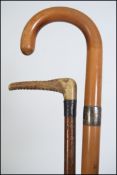 A pair of early 20th century silver collar walking sticks to include malacca shaft,