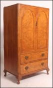 A 1930's Queen Anne walnut tallboy chest of drawers raised on stub cabriole legs with pad feet