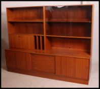 A retro 1970's Clausen and Sons teak upright double sideboard display cabinet having cupboards to
