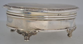 A silver hallmarked ladies jewellery trinket box raised on decorative feet having hinged top and