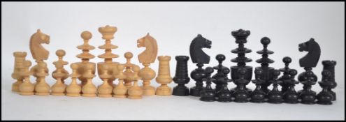 An ebony and boxwood chess set of unusual form in the manner of William Lund,