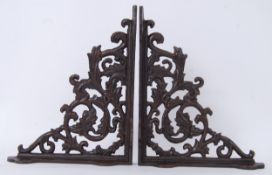A pair of decorative cast iron rust effect hanging brackets.