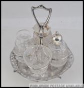 A silver hallmarked cut glass 4 piece cruet set bearing marks for Broadway and Co,