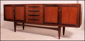 A good retro 1970's long and low G plan Fresco teak sideboard enclosed by moulded panelled door