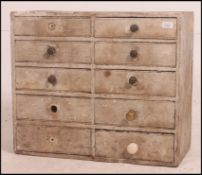 A vintage shabby chic pine painted ten drawer wooden industrial filing / tool chest.