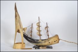 A horn sailing boat converted to a lamp along with a horn Heron type bird carving and a letter