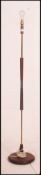 A retro 20th century teak and brass ring column standard lamp supported on a circular base 150cm