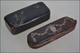 Two 19th century snuff boxes the first being constructed from paper mache with mother of pearl