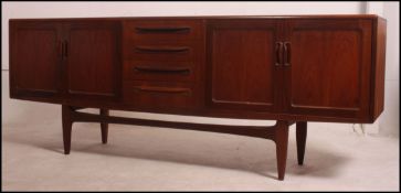 A good retro 1970's long and low G plan Fresco teak sideboard enclosed by moulded panelled door