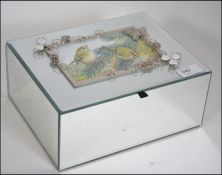 A mirrored glass jewellery box with contents to include costume jewellery such as brooches,