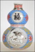 A miniature Chinese glass gourd vase having painted panels depicting cats,