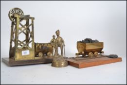 Two large brass sculpture figures of miners,