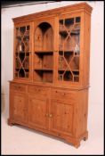 A 20th century pine Regency revival library bookcase cabinet.