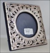 A silver hallmarked fret pierced easel picture frame having a blue velvet backing London assay