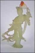 A finely carved Asiatic Jade deity holding a fan in one hand ,