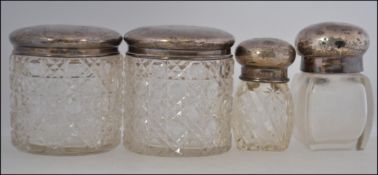 A collection of 4 silver hallmarked dressing table pots,