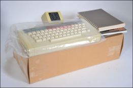 A vintage boxed Acorn computer system dating to the 1980's complete in the box with magazines of