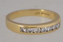 An 18ct gold and diamond channel set ring, the diamonds approx 30pnts.
