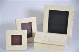 A collection of three 20th century graduating bone desk top picture frames along with a lidded