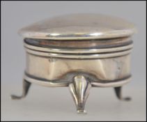 A hallmarked silver antique powder / snuff pot. Standing on three legs, with hinged top.