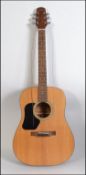 A cased six string Spanish style acoustic guitar by Walden, model number D32 0L,