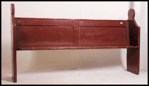 A Victorian small proportioned painted pitch pine pew of eclesiastical form having bench seat with