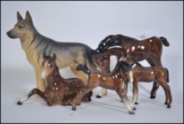 A collection of four Beswick horses and fouls together with a Beswick figure of a Alsatian Tallest