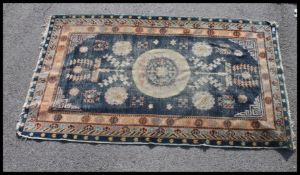 A Khotan blue rug with central roundel and geometric spandrels dating to the 20th century and