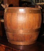 A late 19th early 20th century oak and brass coopered barrel ideal for a fire side log bucket with