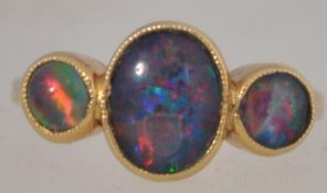 A stunning 18ct gold and 3 stone opal ring of heavy setting,