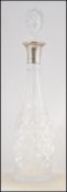 A good silver collared decanter of cut glass form being tall, complete with the stopper.