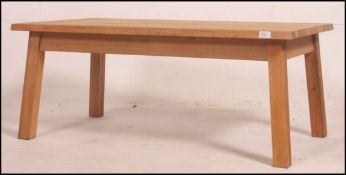 A large solid oak coffee table on chamfered oak legs and frame. 45cm high x 110cm wide x 60cm deep.