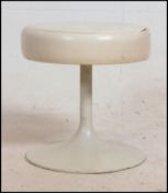 A 1970's unmarked Arkana style dressing table stool on tulip pattern base having a white seat pad .