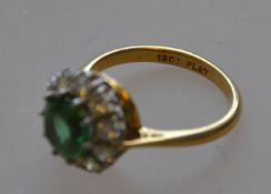 A marked 18ct and platinum green stoned ladies dress ring with diamond surround 4.