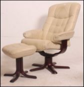 A 20th century cream leather reclining chair and matching ottoman footstool in the manner of
