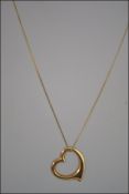 A 9ct gold fine chain necklace having a heart shaped gold pendant