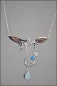 A silver art nouveau style opal set necklace
