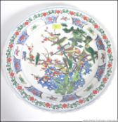 A large Chinese famille rose wall charger having handpainted design of birds and trees with scolled