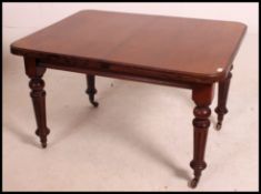 A 19th century mahogany wind out dining table of good quality having an extra leaf.