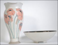 A 20th century studio pot and bowl being hand thrown and wood kiln glazed being decorated with