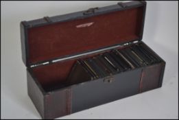 Vintage carry case with hook and eye fastener containing many monochromatic slides for a magic