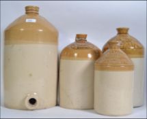 A collection of four 19th century stoneware advertising flagons,