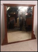 A Victorian large mahogany wall mirror having bevelled mirror glass plate to centre having show