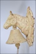 A 20th century cast metal painted wall hanging bell in the form of a horses head H28cm